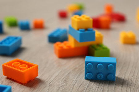 Construction toy. Colorful building bricks on wooden background, closeupの写真素材