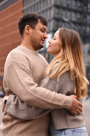 Beautiful happy couple hugging on city street