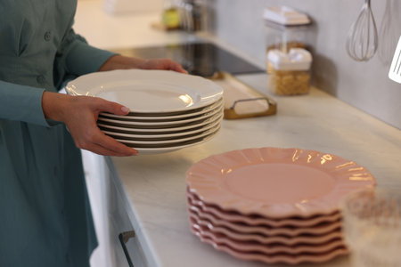 Stacked plates on countertop in kitchen, closeup