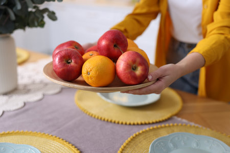 Setting a table with fresh fruits, closeup viewの写真素材