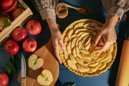 Making homemade apple pie and ingredients on blue wooden table, top viewの写真素材