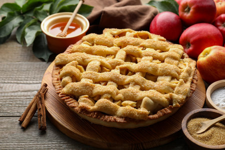 Tasty homemade apple pie and ingredients on wooden table, closeupの写真素材