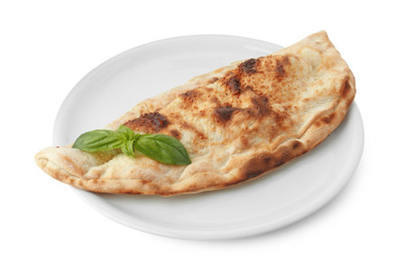 One delicious calzone with fresh basil isolated on whiteの写真素材