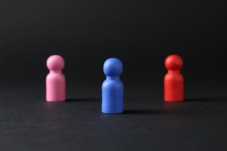 Competition concept. Different human figures on black backgroundの写真素材