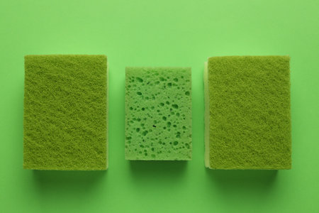 Group of sponges on green background, flat layの写真素材