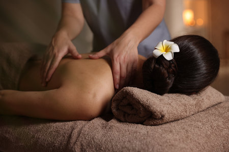 Woman receiving back massage in spa salonの写真素材