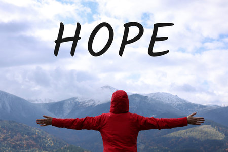 Hope. Happy woman admiring mountain landscape, back viewの写真素材