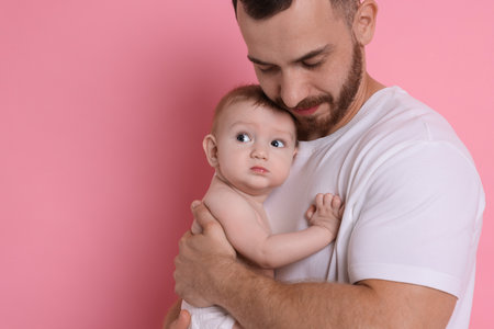 Parent with baby on pink background, space for textの写真素材