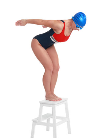 Professional sportswoman in swimsuit, cap and goggles jumping on white backgroundの写真素材
