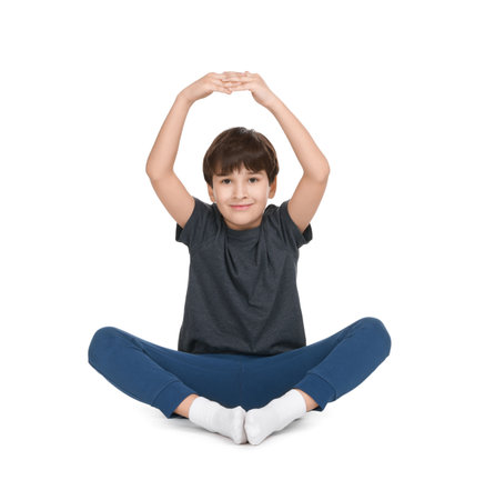 Boy doing exercise on white background. Sport activityの写真素材