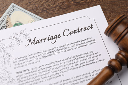 Marriage contract, gavel and dollar bill on wooden table, top viewの写真素材
