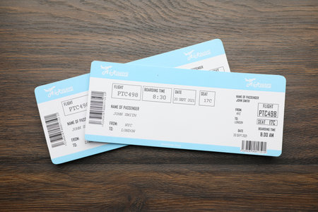 Travel agency. Flight tickets on wooden table, top viewの写真素材