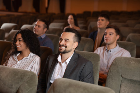 Group of people watching theatrical performance in theatreの写真素材