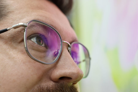Man wearing stylish glasses on blurred background, closeup