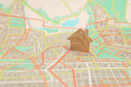Wooden house model on city map. Accommodation searchの写真素材