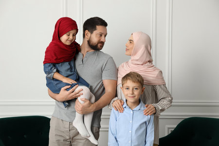 Happy Muslim family spending time together at home