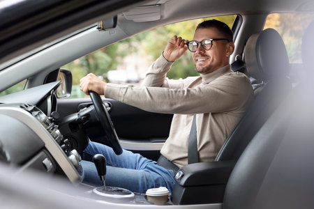 Man driving modern car, view through windowの写真素材