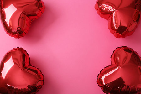 Red heart shaped balloons on pink background, flat lay with space for text. Saint Valentine's day celebrationの写真素材