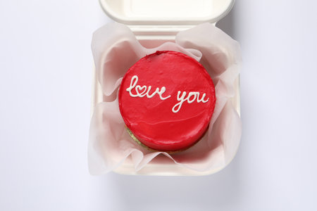Bento cake with Love You text in takeaway box on white table, top view. St. Valentine's day surpriseの写真素材