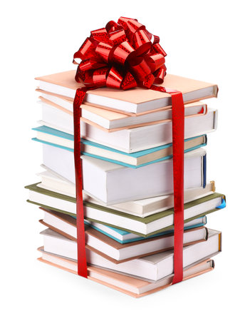 Stack of books with red bow as gift isolated on whiteの写真素材