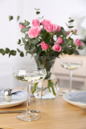 Place setting with pink roses on wooden table. Romantic dinnerの写真素材