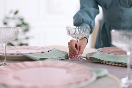 Woman setting table for dinner at home, closeupの写真素材