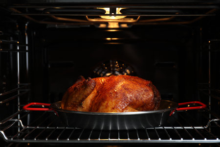 Delicious baked turkey in baking dish in ovenの写真素材