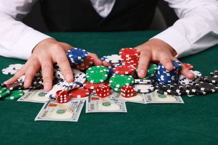 Professional croupier accepting bets at gambling table, closeupの写真素材