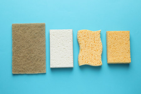 Many sponges on light blue background, flat layの写真素材