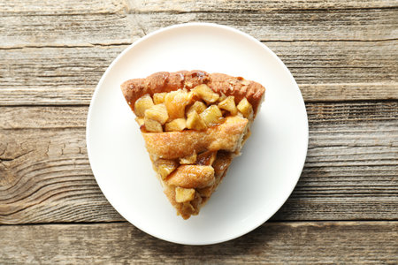 Slice of homemade apple pie on wooden table, top viewの写真素材