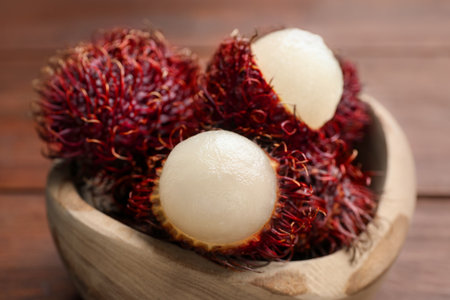 Delicious ripe rambutans in bowl on table, closeupの写真素材