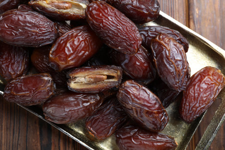 Many tasty dried dates on wooden table, top viewの写真素材