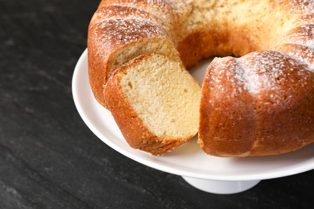 Freshly baked sponge cake on black table, closeupの写真素材