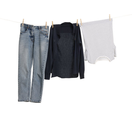 Different clothes drying on laundry line against white backgroundの写真素材