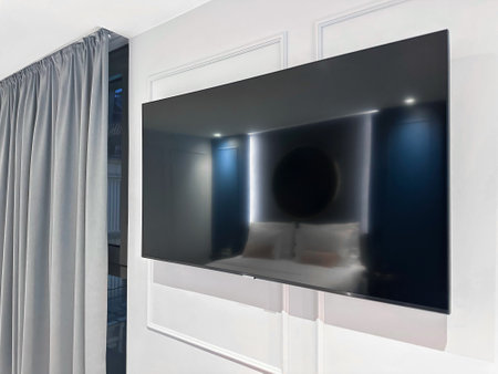 Big modern tv set on white wall in roomの写真素材