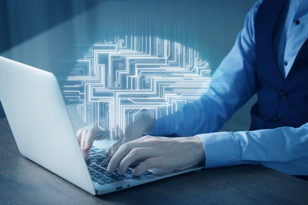 Businessman working on laptop at desk, closeup. Digital brain above computer symbolizing artificial intelligenceの写真素材