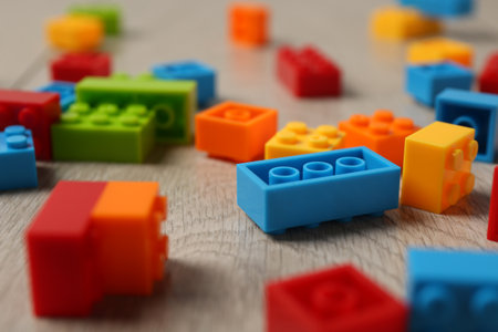 Construction toy. Colorful building bricks on wooden background, closeupの写真素材