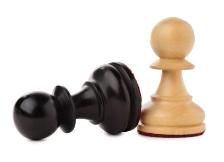 White pawn near fallen black one on white background. Competition conceptの写真素材