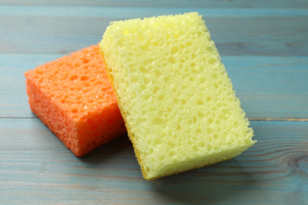 Soft sponges on light blue wooden table, closeupの写真素材