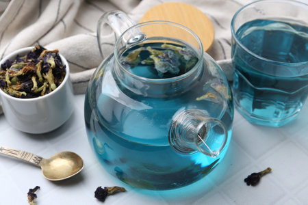 Delicious butterfly pea flower tea on white tiled table, closeupの写真素材