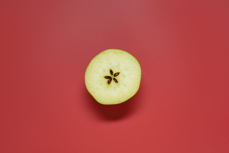Half of fresh ripe apple on red background, top viewの写真素材
