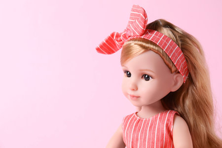 Beautiful doll with headband on pink background, closeup. Space for textの写真素材