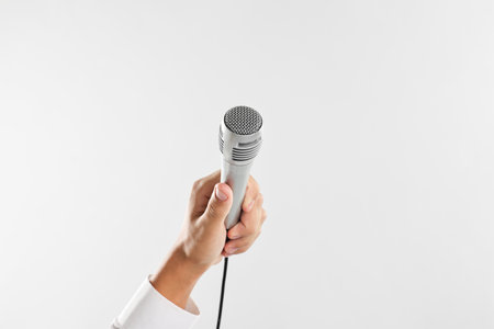 Man with microphone on light gray background, closeupの写真素材