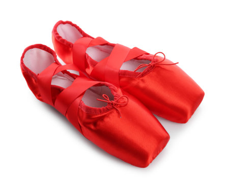 Pair of beautiful red pointe shoes isolated on whiteの写真素材