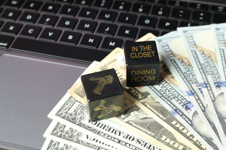 Money and dice on laptop, closeupの写真素材