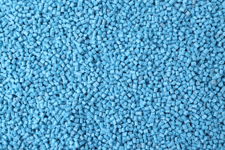Pile of light blue plastic granules as background, top viewの写真素材