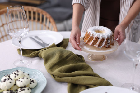 Woman setting table for dinner at home, closeupの写真素材