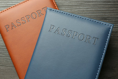 Passports in color covers on wooden table, top viewの写真素材