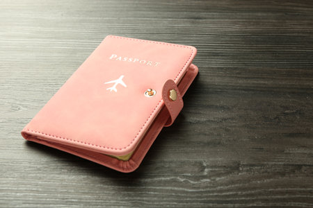 Passport in pink cover on wooden tableの写真素材