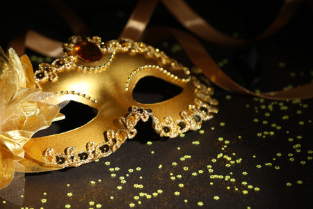 Beautiful carnival mask, ribbon and confetti on dark background, closeupの写真素材